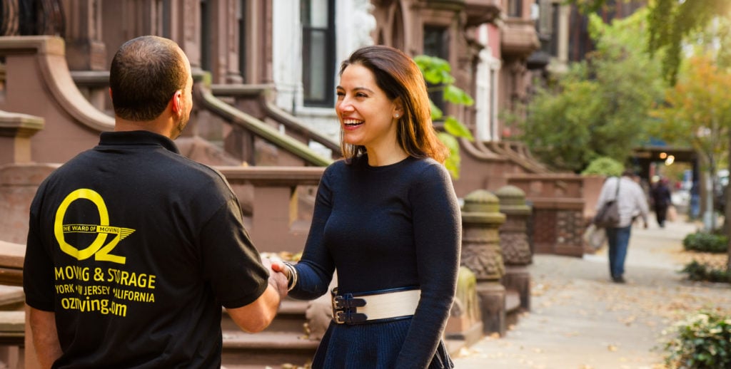 first apartment checklist, woman shaking movers hand