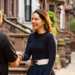 first apartment checklist, woman shaking movers hand