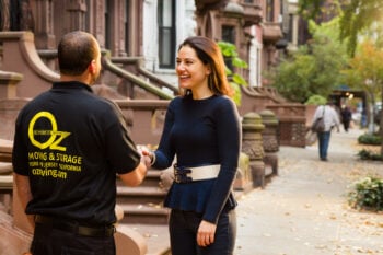 A happy customer with an Oz Moving employee